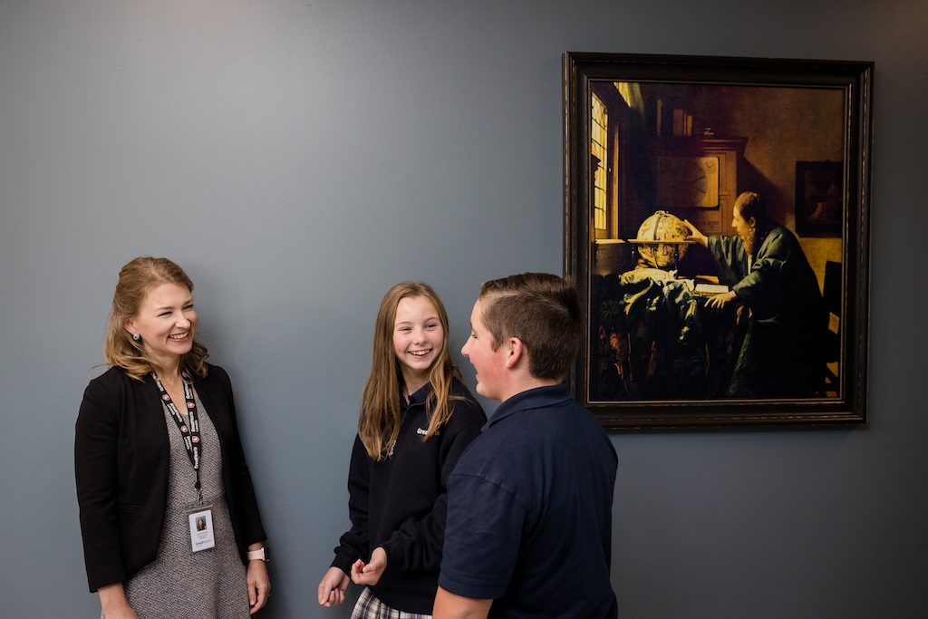 Great Hearts Lakeside middle school students discussing a painting with their headmaster
